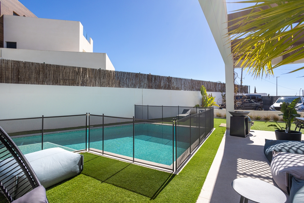 A,Sunny,Backyard,Featuring,A,Rectangular,Swimming,Pool,With,A